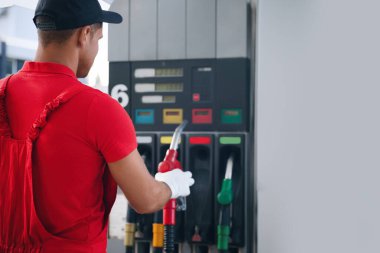 Modern benzin istasyonunda yakıt pompası kullanan işçiler