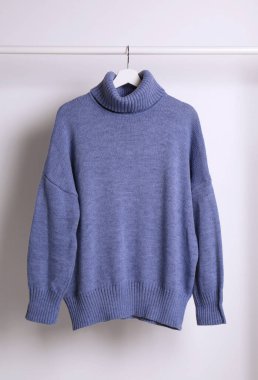 Askıda asılı kalın süveter beyaz arkaplanda