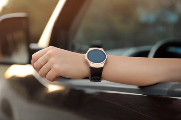 stock image Young woman with smart watch in car, closeup