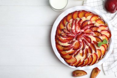 Beyaz ahşap masada erikli nefis bir pasta, düz uzanmış. Metin için boşluk