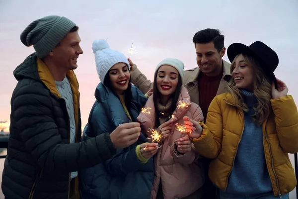 Group People Warm Clothes Holding Burning Sparklers Outdoors — Stock Photo, Image