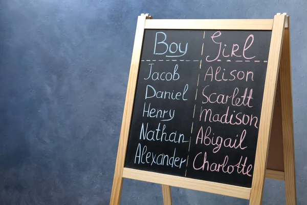 Chalkboard Stand Com Nomes Bebê Fundo Azul — Fotografia de Stock