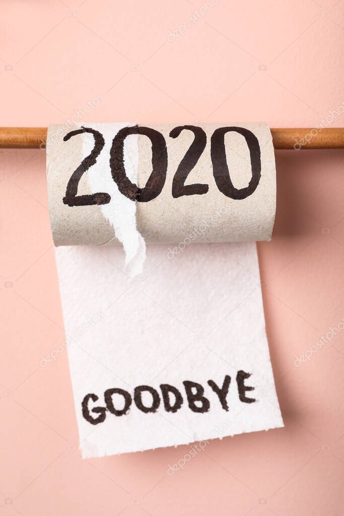 Toilet paper roll with text Goodbye 2020 on pink background