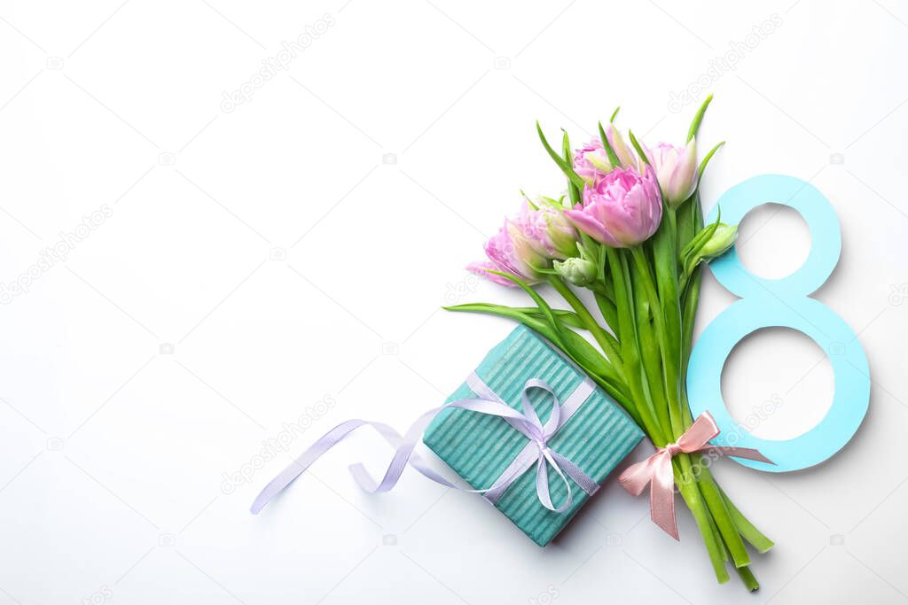 8 March greeting card design with tulips and gift on white background, top view. Space for text