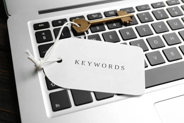 Key with tag KEYWORDS on laptop keyboard,  closeup