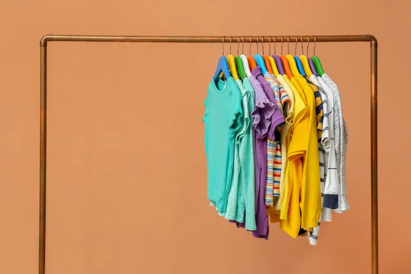 Rack Stylish Children Clothes Beige Background — Stock Photo, Image