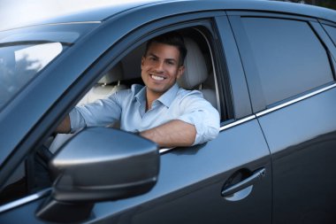 Modern arabasında yakışıklı bir adam, dışarıdan görünüşü var.