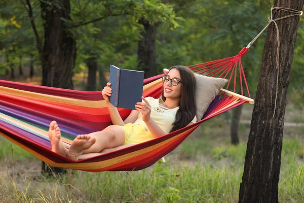 Mladá Žena Čtení Knihy Pohodlné Houpací Sítě Zelené Zahradě — Stock fotografie