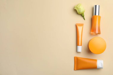 Bej arka planda lüks kozmetik ürünleri seti, düz yatış. Metin için boşluk