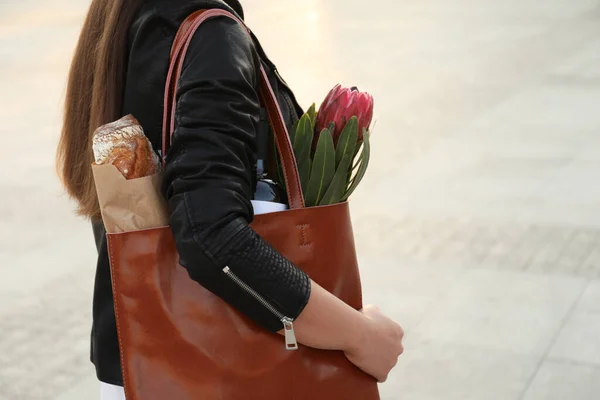 Woman with leather shopper bag outdoors, closeup