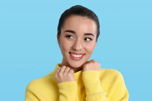 Hermosa Mujer Joven Con Suéter Amarillo Cálido Sobre Fondo Azul —  Fotos de Stock
