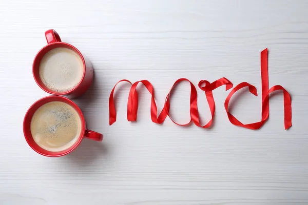 Maart Wenskaart Ontwerp Met Kopjes Koffie Rood Lint Witte Houten — Stockfoto