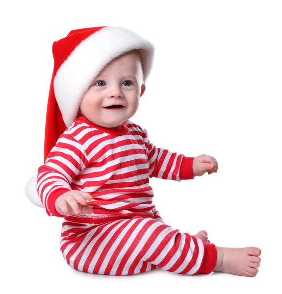 Cute baby in Santa hat and bright Christmas pajamas on white background