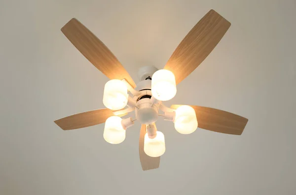 Modern ceiling fan with lamps, low angle view