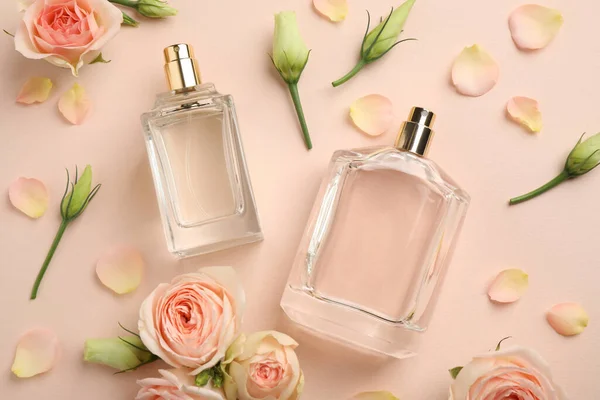 Flat Lay Composition Different Perfume Bottles Fresh Flowers Beige Background — Stock Photo, Image