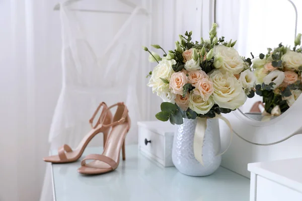 Wedding bouquet, shoes and dress in room