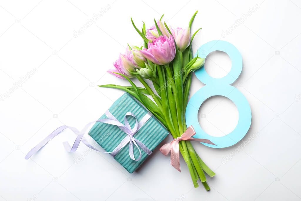 8 March greeting card design with tulips and gift on white background, top view