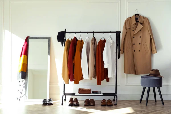 Rack with stylish clothes in modern dressing room