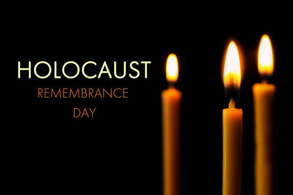 International Holocaust Remembrance Day. Burning candles on black background