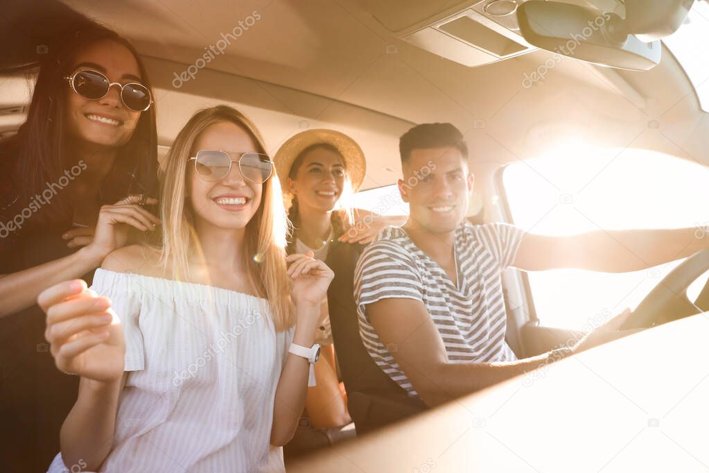 Happy friends together in car on road trip