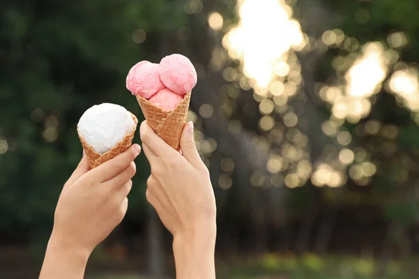 Women with ice cream spending time together outdoors, closeup. Space for text