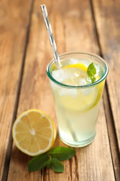 Natural lemonade with mint and fresh fruit on wooden table, closeup. Summer refreshing drink