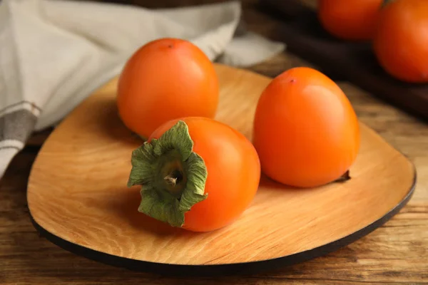 Tasty Ripe Persimmons Wooden Table Closeup — Stock Photo, Image