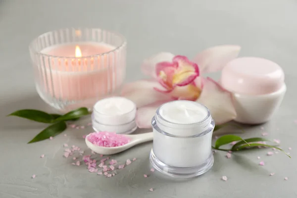 Beautiful Spa Composition Cosmetic Products Flowers Candle Light Grey Table — Stock Photo, Image