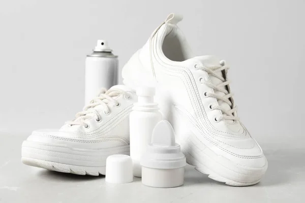 Composition with stylish footwear and shoe care accessories on white background