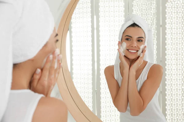 Happy Young Woman Applying Cleansing Foam Face Mirror Bathroom — Stock Photo, Image
