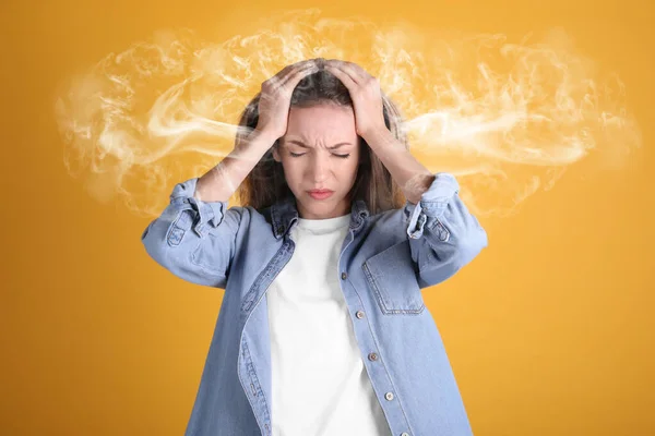 Stressed and upset young woman on yellow background