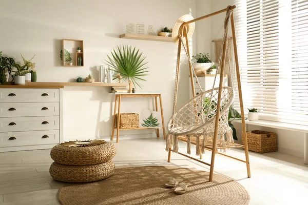 Comfortable hammock chair in stylish room. Interior design