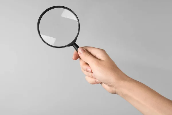 Mujer Sosteniendo Lupa Sobre Fondo Gris Primer Plano Buscar Concepto —  Fotos de Stock