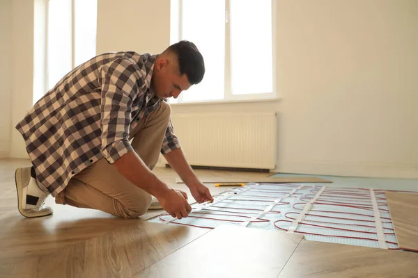 Professional Worker Installing Electric Underfloor Heating System Indoors — Stock Photo, Image