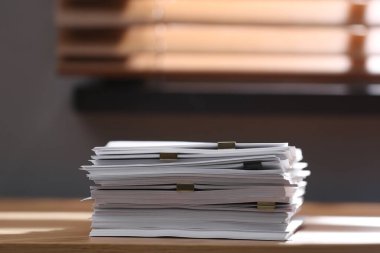 İçerideki ahşap masada ataçları olan boş kağıt yığını. Metin için boşluk