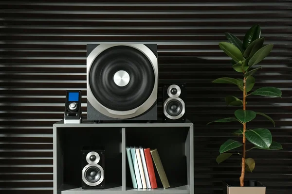 Modern audio speaker system on shelving indoors