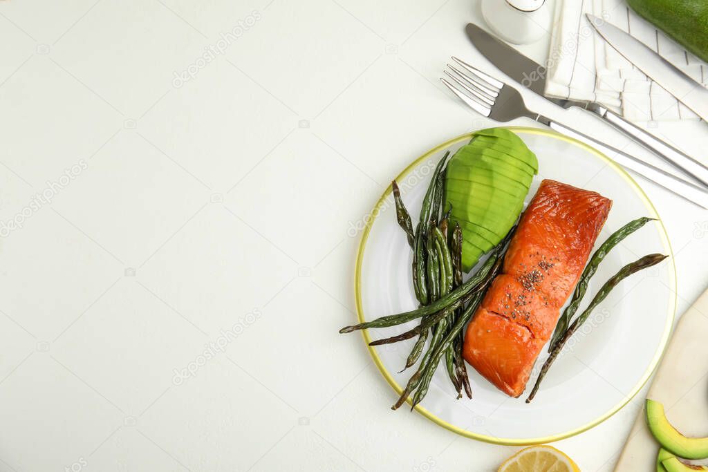 Tasty cooked salmon and vegetables served on white table, flat lay with space for text. Healthy meals from air fryer