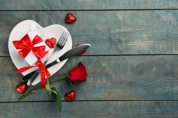 Beautiful table setting on wooden background, flat lay with space for text. Valentine\'s Day dinner