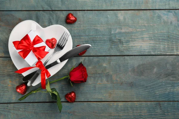 Beautiful table setting on wooden background, flat lay with space for text. Valentine's Day dinner