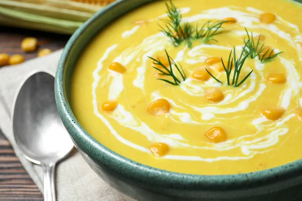 Delicious creamy corn soup in bowl, closeup