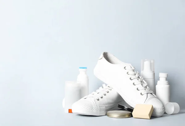 Composition with stylish footwear and shoe care accessories on white background