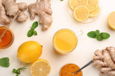 Dokunulmazlık artırıcı içecek ve beyaz arka planda malzemeler, düz yatıyordu