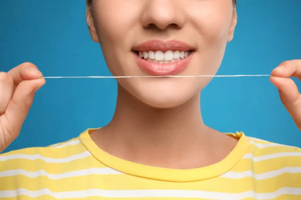 Jovem Mulher Usando Fio Dental Nos Dentes Fundo Azul Close — Fotografia de Stock