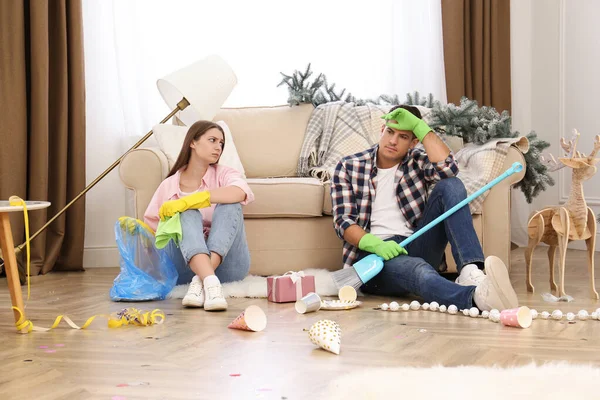 Tired Couple Sitting Messy Room While Cleaning New Year Party — Stock Photo, Image