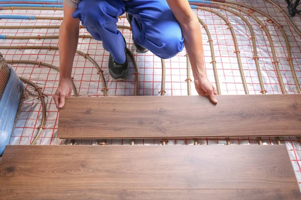 Worker Installing New Wooden Laminate Underfloor Heating System Closeup — Stock Photo, Image