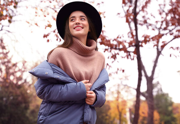 Young woman wearing stylish clothes in autumn park