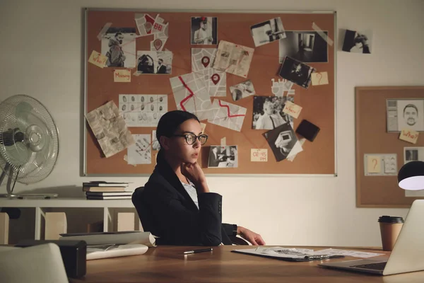 Detective working at desk in her office