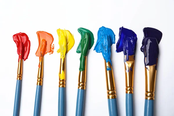 Set Brushes Different Paints White Background Flat Lay Rainbow Colors — Stock Photo, Image