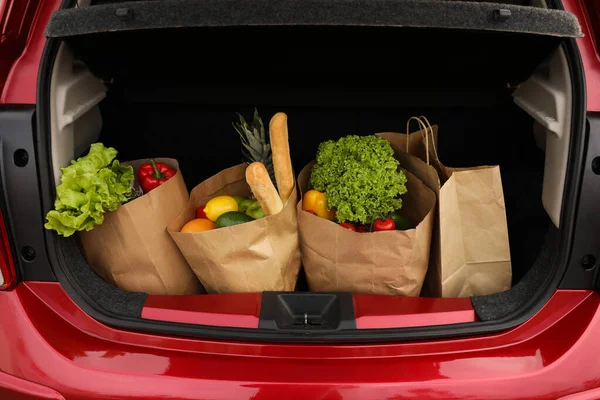 Bags full of groceries in car trunk, closeup view