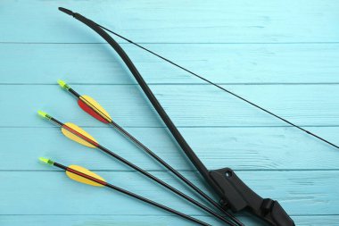 Plastik oklar ve turkuaz ahşap masa, düz yatış. Okçuluk spor ekipmanları